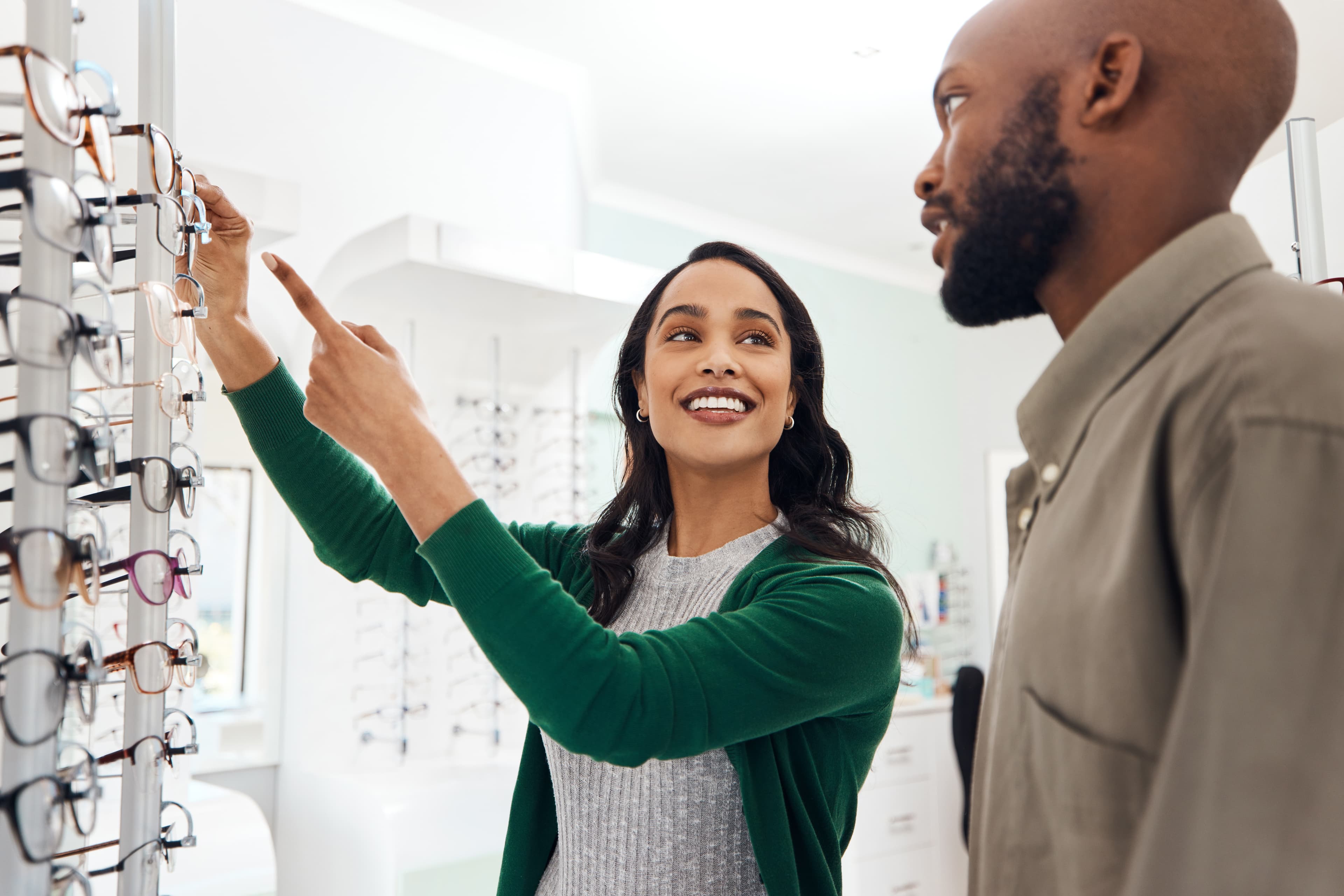 A team member helping a patient choose eyewear at Vine Eye Care